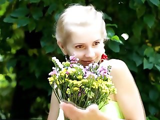 beautiful fresh blonde girl loves flowers