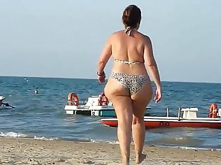 Fat Bottomed Mature Jiggling Down The Beach In Bikini
